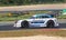 BMW sport touring racing car action on asphalt track side view