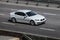 BMW white speeding on empty highway