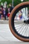 A BMX bike wheel against the backdrop of a blurred street with c