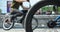 A BMX bike wheel against the backdrop of a blurred street with c