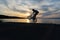 Bmx biker silhouette doing tricks against the sunset.