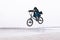BMX freestyle. toddler jumps on a BMX bike. BMX rider makes tricks on the background of the river