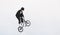 BMX freestyle. Young BMX bicycle makes tricks on the white background. Copyspace