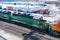 A BNSF diesel locomotive pulls multiple BNSF motive power in various historical color schemes showing years of mergers