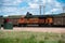 BNSF locomotive 9337 idles in a yard filled with loaded coal hoppers ready for eastbound delivery
