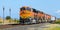 BNSF mixed freight train at Stanwood Washington under a blue sky
