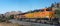 BNSF railroad locomotives haul a freight train toward famous Tehachapi Loop, California