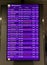 Board at the airport with a list of flights listing the cities of arrival, flight numbers, status, departure time and gate in