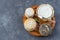 Board of Corsican specialities, varity of goat and sheep cheese with mimosa flower, on a grey slate background