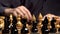 Board game of chess. The player cuts pieces in chess. Sports Strategy and gambling. the player is a man at a table in a dark key.