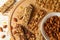 Board with granola bars and bowl with  almond on wooden background, top view