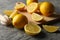 Board, lemons and juicer on background. Ripe fruit