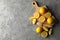 Board, lemons and juicer on background. Ripe fruit