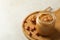 Board with peanut, spoon and jar with peanut butter on white background