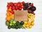 Board in rainbow frame of fruits and vegetables