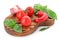 Board with ripe cherry tomatoes with vegetables and herbs on white background