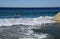 Board surfer searching for a place to surf at Aliso Beach in Laguna Beach, California.