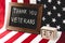 Board with thank you veterans lettering near flag of america and cubes with date