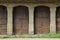 Boarded arches of a warehouse. Front view of the shuttered brick arches