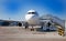 Boarding passengers on the plane. Boarding bridge. The plane lands at the international airport. Loading luggage. White