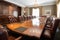 boardroom with long wooden table and leather chairs for formal meetings