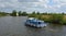 Boards Cruiser and Yacht under sail navigating the river Bure near Horning, the Norfolk Broads.