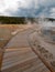 Boardwalk curving around Hot Cascades hot spring in the Lower Geyser Basin in Yellowstone National Park in Wyoming