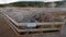 Boardwalk curving around Hot Cascades hot spring in the Lower Geyser Basin in Yellowstone National Park in Wyoming USA