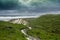 Boardwalk through green vegetation at Conspicuous Cliff during stormy weather in Western Australia..