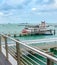 Boardwalk by harbor with ships