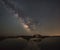 Boardwalk leading towards a shack and Milky Way Galaxy