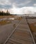 Boardwalk next to Tangled Creek and Black Warrior Springs leading into Hot Lake in Yellowstone National park in Wyoming USA