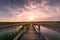 Boardwalk over salt marsh at sunset