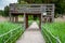 Boardwalk path through wetlands area with wooden viewing tower .