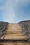 Boardwalk pathway to a sandy beach in summer with blue sky