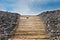 Boardwalk pathway to a sandy beach in summer with blue sky