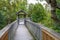 Boardwalk with railing through a forest on a cloudy day, Katmai National Park, Alaska