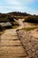 Boardwalk through the sand dunes to a quiet sandy beach