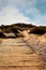 Boardwalk through the sand dunes to a quiet sandy beach