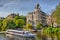 Boat on Amstel river near beautiful houses in Amsterdam, Holland, Netherlands, HDR
