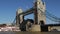 Boat approaches Tower Bridge\'s open drawbridge