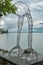 Boat approaching abstract strange statue on shores of Lake Geneva in Montreux