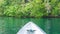 Boat approaching rocks overgrown with Palmtrees in Hidden Bay on Gam Island near Kabui and Passage. West Papuan, Raja