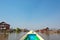 Boat arriving in a colorful floating village with stilt-houses in Burma Myanmar