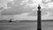 Boat arriving to harbour with column and seagulls black and white. Seagulls in port with ship monochrome.