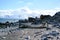 Boat on beach of Halfmoon Island, Antarctica. Abandoned wooden whaling boat laying on beach with rocks and chinstrap penguins.