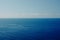 Boat on blue sea surface aerial view. Nature background