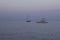 Boat in blue sea, yacht in evening ocean after sunset