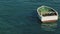 Boat bobbing in the waves in open sea in windy and sunny day