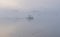 Boat and Brids on a Lake in the fog